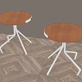Two Stools With Brown Leather Seats And Silver Star Shaped Metal Legs On Herringbone Floor