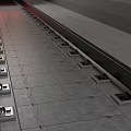 Yellow Train Moving Through Underground Tunnel With Railway Track And Pipes