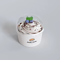 Delicious Whipped Cream Dessert In White Cup With Chocolate Shavings Blueberries And Nom Nom Logo