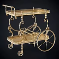 Elegant Gold Two Tiered Commercial Service Cart With Ornate Metal Frame And Decorative Wheels