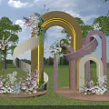 Outdoor Wedding Decoration With Rainbow Arch Flower Arrangements Green Grass And Trees
