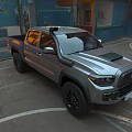 Silver Pickup Truck Parked In Urban Area With Graffiti Walls