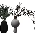 Modern Black Ribbed And White Round Vases With Green Foliage And Twigs Decor