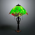 Decorative Table Lamp With Intricate Black Metal Base And Green Stained Glass Shade