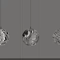 Modern Pendant Lights With Moon Like Cratered Texture Hanging In Minimalist Interior