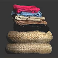 Colorful Fabrics With Soft Textures Stacked On Woven Mats Black Background