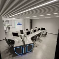 Modern Monitoring Room Interior With Multiple Computer Monitors Ergonomic Chairs And Blue LED Desks