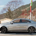 Silver Audi Sedan Parked On Roadside With Wooden Building Background And Alloy Wheels