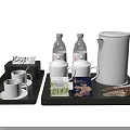 Elegant Tea Set with Black Trays White Teapot Cups Bottled Water and Tea Bags on