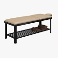Massage Bed with Black Frame Gray Beige Blanket Pillows and Lower Shelf Stacked Towels