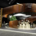 Modern Exhibition Space With Curved Wooden Structure Digital Screen And Green Plant