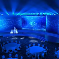 Modern Conference Venue With Blue Lighting Large Screen And Round Tables