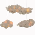 Fluffy Cloud Shaped Chandeliers With Lit Interior Hanging As Decorative Lighting Fixtures