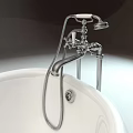 Elegant White Freestanding Bathtub With Ornate Metal Feet And Silver Faucet