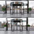 Modern Building Entrance With Glass Revolving Door And Potted Green Plants