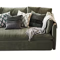 Luxurious Green Velvet Sectional Sofa With Multiple Decorative Pillows And Cozy Throw Blanket
