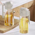 Transparent Condiment Bottles With Grey Lids On Wooden Cutting Board Kitchen Countertop With Lemons