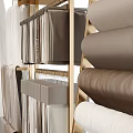 Elegant Curtains Display With Various Fabrics On Modern Golden Racks And Table