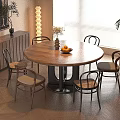 Modern Dining Area with Round Wooden Table Chairs Fruits Vase Lamp and Cabinet