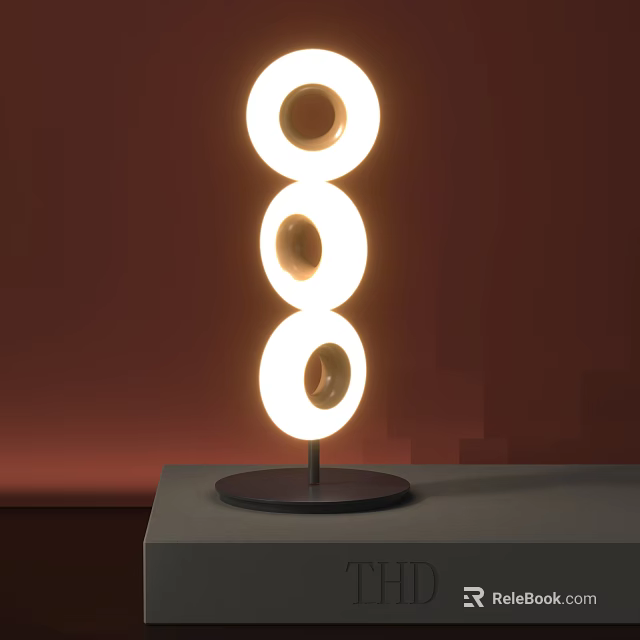 Unique Shaped Table Lamp with Three Circular Illuminated Rings on Gray Tabletop Against Red Background 3d model