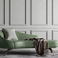 Elegant Green Chaise Lounge With Pillow And Throw Blanket Against Paneled Wall