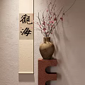 Traditional Vase With Pink Flower Branches On Red Stand By Beige Wall Calligraphy Scroll