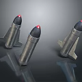 Three Metallic Military Bombs with Red Tips and Fins on Reflective Surface