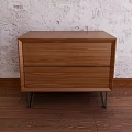 Wooden Bedside Table With Two Drawers And Metal Legs On Textured Wall Wooden Floor