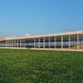 Modern Flower Market Building With Glass Structure Green Lawn And Red Signage