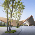 Modern Geometric Architecture With Triangular Metal Roof Glass Curtain Wall Open Plaza And Grassland