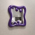 Stylish Purple Irregular Shaped Mirror in Bedroom with Bed Pillows and Copper Decor