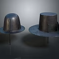 Two Shiny Metal Hat Shaped Household Items With Wide Brims On Dark Background
