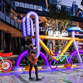 Vibrant Outdoor Photo Check In Spot Featuring Bicycle Shaped Art Installations And Neon Signs