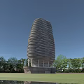 Modern Tall Building With Spiral Exterior Design Surrounded By Green Trees And Blue Sky