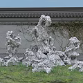 Traditional Chinese Garden Rockery Stones With Ancient Wall Grey Tiled Roof And Green Vines