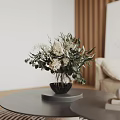 Elegant Living Room Interior Featuring Round Table Dried Flower Arrangement Black Vase And Beige Sofa
