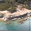 Natural Microtopography Featuring Layered Rock Formations Clear Water And Coastal Vegetation