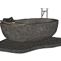 Stone Bathtub on Pebble Base with Wooden Tray Holding Black Towels Against White Walls