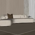 Beige Curved Sofa with Brown Cream Pillows on Light Rug Light Walls Window Blinds