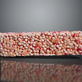 Rice Crispy Treat with Orange and Pink Sprinkles on Black Surface with Reflection