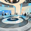 Modern Exhibition Hall With Circular Platform Large Screens Lighting Design And Visitors