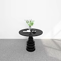 Modern Black Round Dining Table With Spiral Base Green Plant White Cup And Black Decor