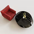 Red Woven Accent Chair with Black Round Marble Coffee Table and Small Plant