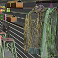 Gray Wall Retail Display With Hanging Shirts Orange Boxes And Stools