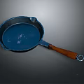 Stylish Blue Frying Pan With Wooden Handle And Round Design For Kitchen Use