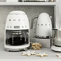 Stylish White SMEG Kitchen Appliances Coffee Maker Kettle And Stand Mixer In Modern Kitchen Setting
