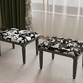 Two Stools With Black And White Floral Upholstery Dark Wooden Legs In Room Setting