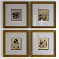 Classical Portrait Paintings With Golden Frames Hanging On White Wall
