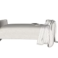 Cozy Beige Linen Upholstered Footstool With Draped Knitted Blanket And Book