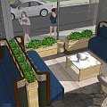 Modern Outdoor Public Chair With Blue Seats Green Plants And Square Tables On Paved Floor